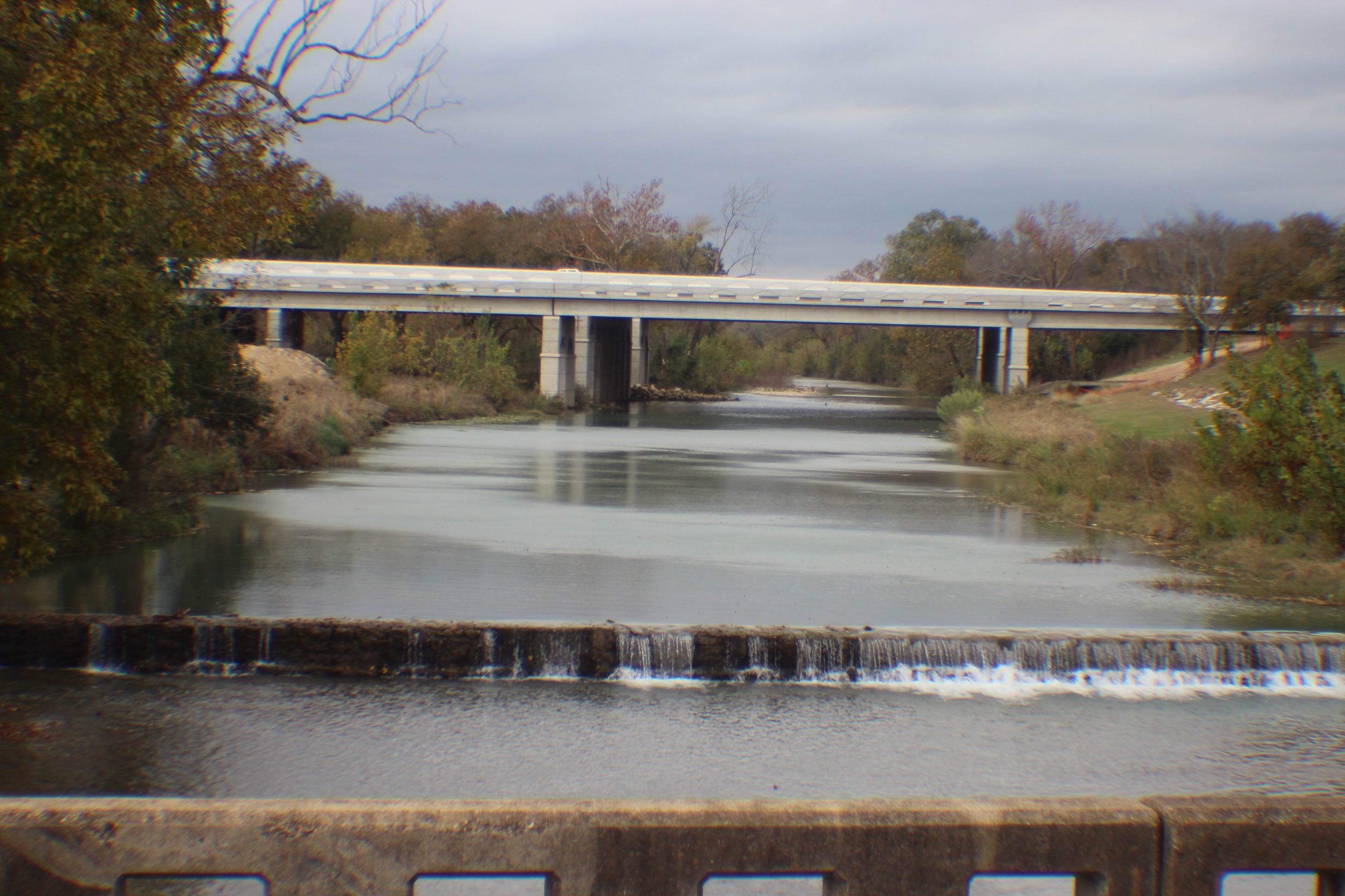 Water flowing over the low dam at Salado Creek in Salado, Texas