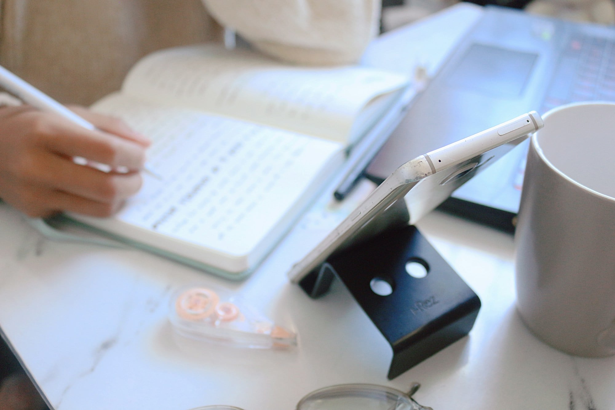 Writing notes in a notebook at a desk