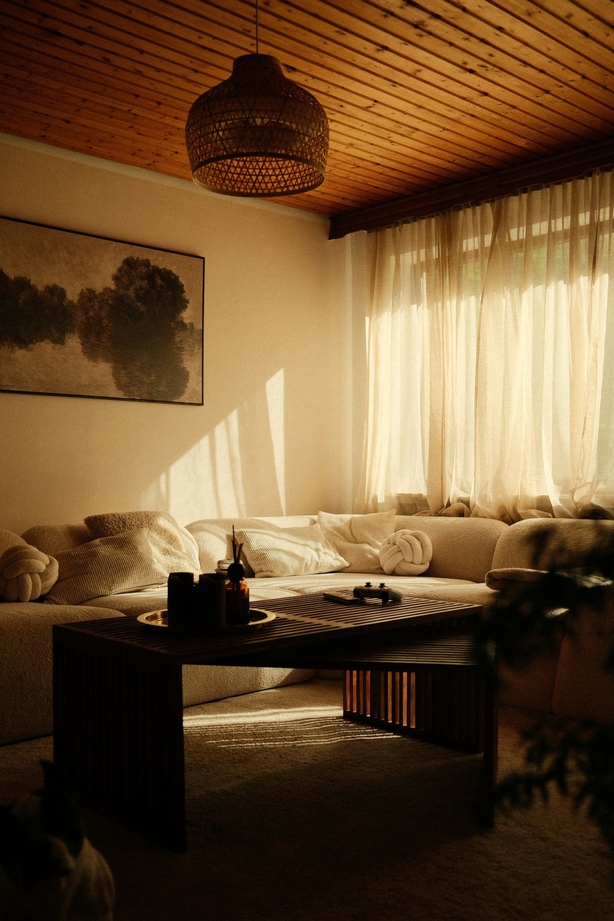 A light-filled living room with a sofa and wooden coffee table