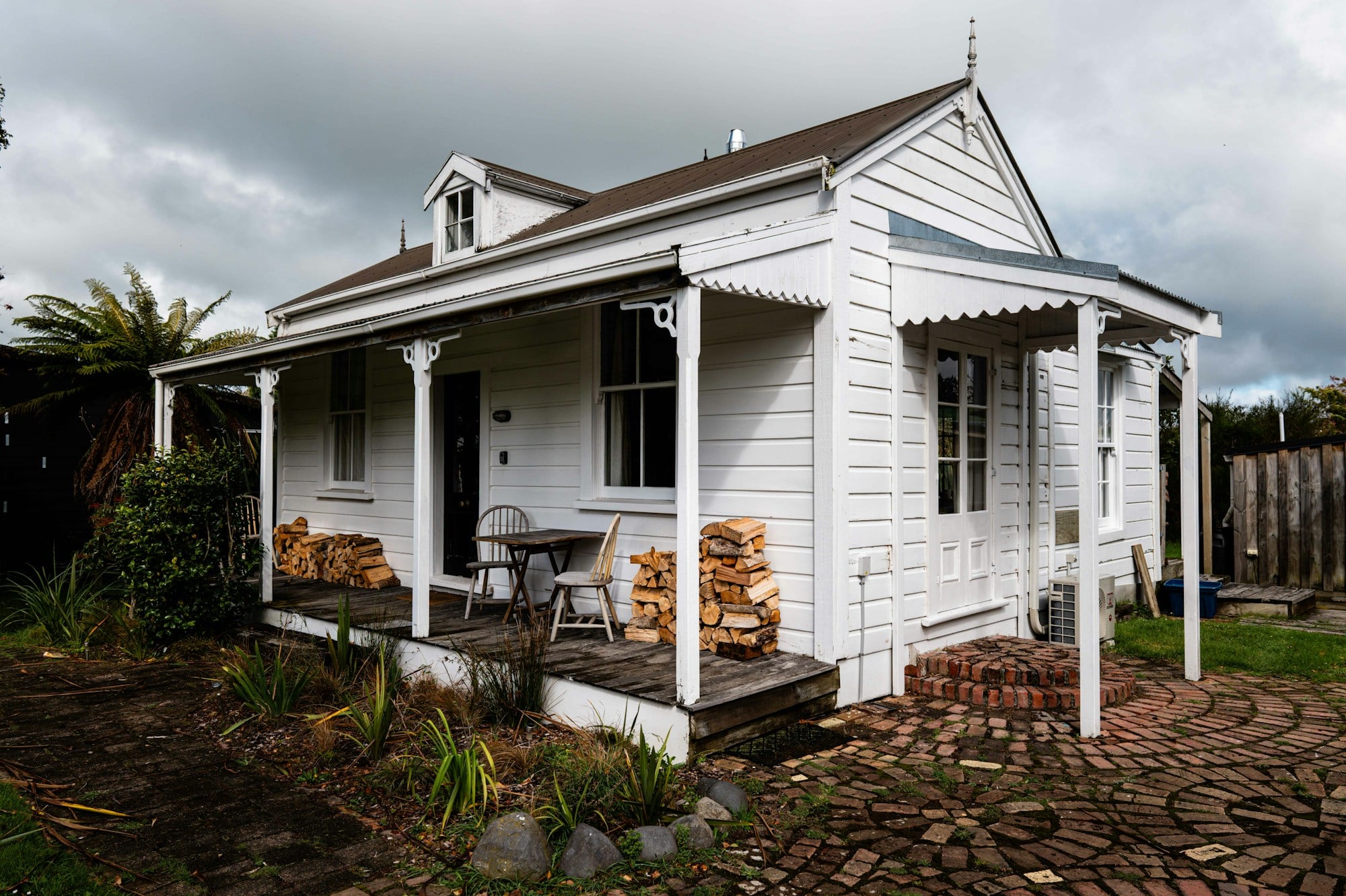 A white cottage with a covered front porch